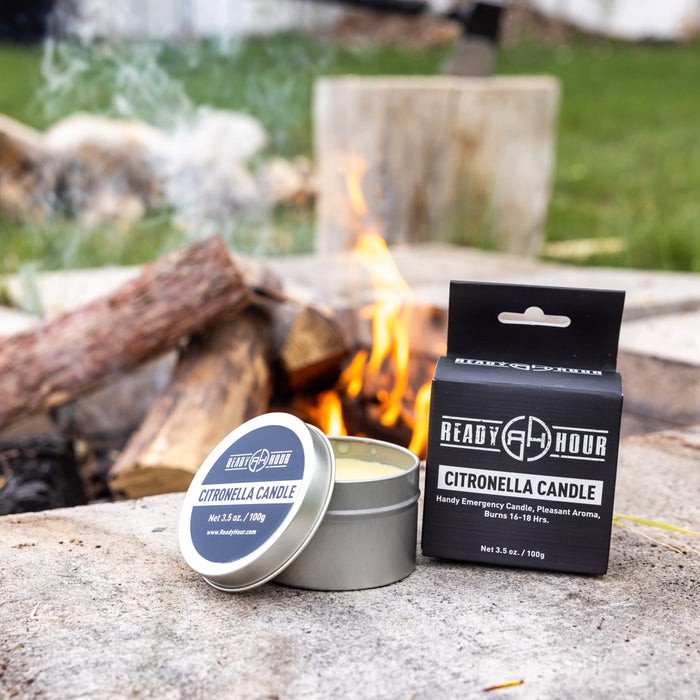 citronella candle and box sitting next to a campfire