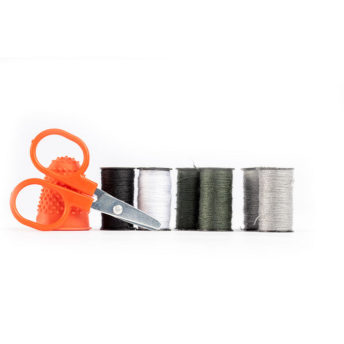 Components of Emergency Sewing kit including thread, scissors, and thimble