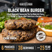 Black bean burgers on a cutting board with lettuce and bun
